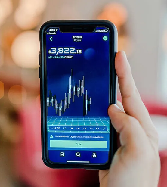 Smartphone showing Bitcoin price chart with a value of $3,822.18 and a rising graph
